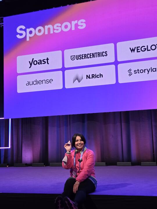 Isabel speaking on stage at a conference